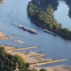 Cargo ships travel on the Rhine River on August 10, 2022 near Bonn, Germany. The ongoing hot weather and lack of rain have caused water levels on the Rhine to fall, which is complicating shipping.